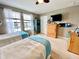 Bright bedroom with twin beds, large windows, and neutral color palette at 11611 Lake Blvd, New Port Richey, FL 34655