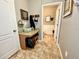 Entryway featuring decorative touches and a peek into a half bathroom with wainscoting and tiled floors at 11611 Lake Blvd, New Port Richey, FL 34655