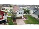 Two-story home with a pool, two-car garage, brick driveway, and a manicured lawn at 11611 Lake Blvd, New Port Richey, FL 34655