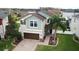 Charming two-story home with a well-manicured lawn, brick driveway and a beautiful palm tree in the front yard at 11611 Lake Blvd, New Port Richey, FL 34655