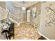 Bright foyer with tiled floors, elegant staircase, and decorative trim at 11611 Lake Blvd, New Port Richey, FL 34655