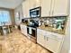 Bright kitchen features stainless steel appliances, granite countertops, and a mosaic tile backsplash at 11611 Lake Blvd, New Port Richey, FL 34655