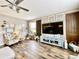 Cozy living room with wood-look flooring, stylish decor, and a large television at 11611 Lake Blvd, New Port Richey, FL 34655