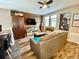 Living room with wood floors, wood accent wall, and comfortable seating at 11611 Lake Blvd, New Port Richey, FL 34655