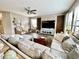 Open living area with hardwood-style floors, lots of light, and a large sectional sofa at 11611 Lake Blvd, New Port Richey, FL 34655