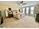 Spacious primary bedroom with a large bed, lots of natural light, and warm, neutral tones at 11611 Lake Blvd, New Port Richey, FL 34655