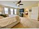 Bright main bedroom with attached ensuite bathroom, large windows, and stylish dresser at 11611 Lake Blvd, New Port Richey, FL 34655