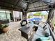 Inviting outdoor living space featuring a cozy gazebo, comfortable seating, and a view of the sparkling blue pool at 11611 Lake Blvd, New Port Richey, FL 34655