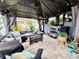 Covered patio with an outdoor kitchen, comfortable furniture, and plenty of seating space at 11611 Lake Blvd, New Port Richey, FL 34655