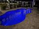 Inviting pool and spa with lights, brick pavers, tropical landscaping, and lounge chairs create a private outdoor oasis at 11611 Lake Blvd, New Port Richey, FL 34655