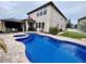 An inviting backyard pool with a spa, covered patio, and lush landscaping at 11611 Lake Blvd, New Port Richey, FL 34655