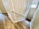 Staircase with wood stairs, white railings, and decorative wall trim at 11611 Lake Blvd, New Port Richey, FL 34655