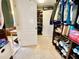 Walk-in closet with custom wood shelving and carpet flooring offers an abundance of storage space at 11611 Lake Blvd, New Port Richey, FL 34655