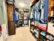 Spacious walk-in closet features custom shelving, ample storage for clothing and shoes, and carpet flooring at 11611 Lake Blvd, New Port Richey, FL 34655