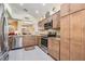 Well-lit kitchen with stainless steel appliances, granite countertops, and ample cabinet space at 1216 Winding Willow Dr, Trinity, FL 34655