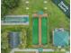 Aerial view of community sports courts featuring shuffleboard and bocce ball with covered seating areas at 1216 Winding Willow Dr, Trinity, FL 34655