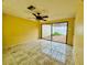 Bedroom with tile flooring and sliding doors to outdoor patio at 12813 Settlers Dr, Hudson, FL 34667