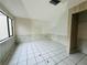 Neutral bedroom featuring tile floors, a window, and neutral walls for personalization at 12813 Settlers Dr, Hudson, FL 34667