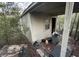 House with a neglected backyard with debris and overgrown vegetation at 13140 Moon Rd, Brooksville, FL 34613