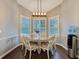 Bright breakfast nook featuring white wainscoting, wooden table and decorative shutters at 13217 Jessica Dr, Spring Hill, FL 34609