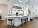 Modern kitchen with white cabinets, a breakfast bar with stools, and hardwood floors at 13217 Jessica Dr, Spring Hill, FL 34609