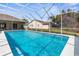 Beautiful backyard pool featuring a screened enclosure and inviting blue water for outdoor enjoyment at 14356 Bronte Ct, Hudson, FL 34667