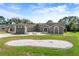 Inviting single-story home with gray exterior, well-kept lawn, and decorative rock landscaping at 14448 Linden Dr, Spring Hill, FL 34609