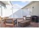 Outdoor patio area with brick pavers, white privacy fence, seating, and table at 15384 Caravan Ave, Odessa, FL 33556