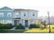 Charming townhome with a well-manicured lawn and beautiful landscaping at 15384 Caravan Ave, Odessa, FL 33556