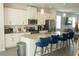 Modern kitchen with granite countertops, stainless steel appliances and stylish island seating at 15384 Caravan Ave, Odessa, FL 33556
