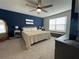 Bedroom with stylish accent wall, ceiling fan, and lots of natural light at 15384 Caravan Ave, Odessa, FL 33556