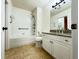 Bright bathroom featuring a shower-tub combo, granite countertop, and tile flooring at 19325 Water Oak Dr # 205, Port Charlotte, FL 33948
