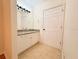 View of bathroom vanity with granite countertops, tile floors, and a decorative lighting fixture at 19325 Water Oak Dr # 205, Port Charlotte, FL 33948