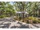 Gated entrance to community featuring lush landscaping, mature trees, and a guard house at 19325 Water Oak Dr # 205, Port Charlotte, FL 33948