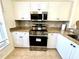 Kitchen featuring granite countertops, stainless steel appliances, and ample cabinet space at 19325 Water Oak Dr # 205, Port Charlotte, FL 33948