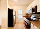 Kitchen featuring stainless steel appliances, granite countertops, and ample cabinet space at 19325 Water Oak Dr # 205, Port Charlotte, FL 33948