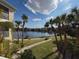 A beautiful lake view framed by palm trees, enhances the outdoor experience, and provides serene scenery at 19325 Water Oak Dr # 205, Port Charlotte, FL 33948