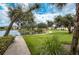 Path overlooking a pond with grassy common area in a lush tropical setting at 19325 Water Oak Dr # 205, Port Charlotte, FL 33948