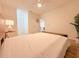 Bright main bedroom featuring a ceiling fan, neutral walls, and a doorway to another room at 19325 Water Oak Dr # 205, Port Charlotte, FL 33948