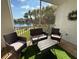 Relaxing screened patio featuring outdoor furniture and views of the lake, perfect for enjoying the outdoors at 19325 Water Oak Dr # 205, Port Charlotte, FL 33948