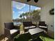 Cozy screened patio with comfortable seating, views of the lake, and a relaxing outdoor space at 19325 Water Oak Dr # 205, Port Charlotte, FL 33948