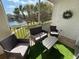 Enjoy outdoor living on the screened patio with comfortable furniture and scenic lake views at 19325 Water Oak Dr # 205, Port Charlotte, FL 33948