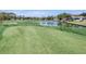 Scenic golf course view with manicured lawns and a tranquil lake at 2050 Quailwood Ln, Spring Hill, FL 34606