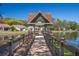 Picturesque lake view from a gazebo-covered pier with seating for peaceful relaxation at 2050 Quailwood Ln, Spring Hill, FL 34606