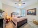 Charming bedroom featuring a ceiling fan, and a large, framed art piece at 21804 Briske Morning Ave, Land O Lakes, FL 34637