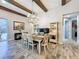 Dining room with wood beams, chandelier and wood-look tile flooring at 21804 Briske Morning Ave, Land O Lakes, FL 34637