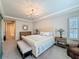 Spacious main bedroom with tufted headboard and decorative chandelier at 21804 Briske Morning Ave, Land O Lakes, FL 34637