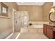 Luxurious bathroom featuring a separate shower and soaking tub with gold fixtures at 2422 Caribou Dr, Spring Hill, FL 34608