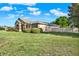 Beautiful home featuring stone accents, a well-kept lawn, and a side entry garage at 2422 Caribou Dr, Spring Hill, FL 34608