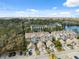 Aerial view of condo community featuring water views and lush greenery at 2764 Countryside Blvd # 3, Clearwater, FL 33761